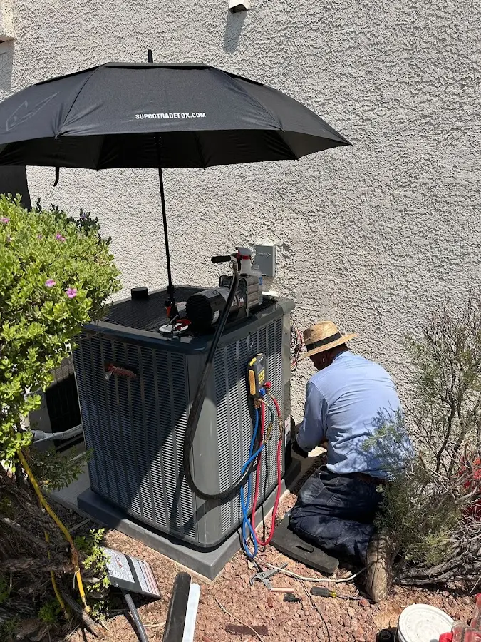 HVAC technician performing outdoor AC maintenance in Orlovista
